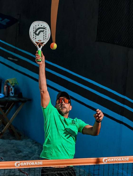 Padel player smashing at the net
